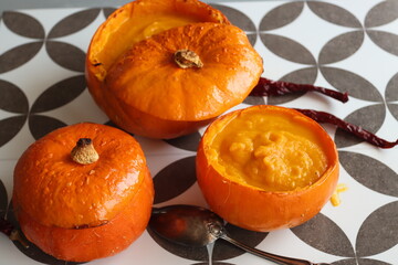 Pumpkin soup on a table. Delicious autumn soup made of carrots, sweet potato and butternut squash. Comfort food concept. 
