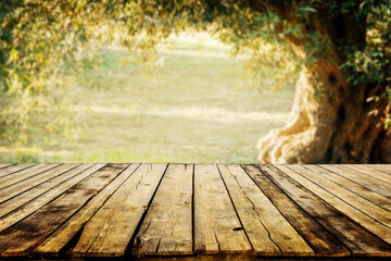 Old wooden table  for product display with natural green olive field bokeh background. Natural...