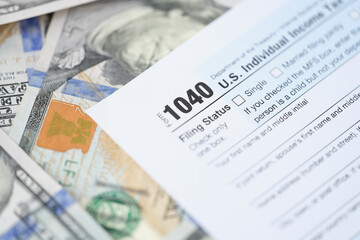 Individuals tax return form 1040 and dollars are on table