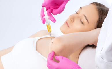 Doctor doing stem cell therapy on a patient's elbow after the injury. Treating knee pain with...