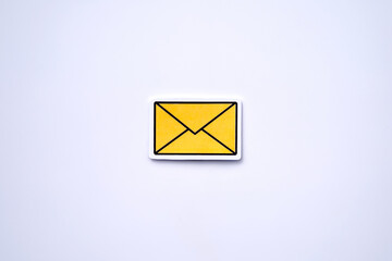 Yellow message sign or envelope against white background