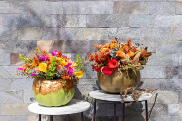 Floral arrangement of roses inside decorated pumpkin