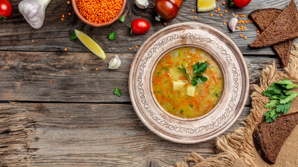 Red lentil soup on wooden background, Traditional turkish or arabic soup. banner, menu recipe place for text, top view
