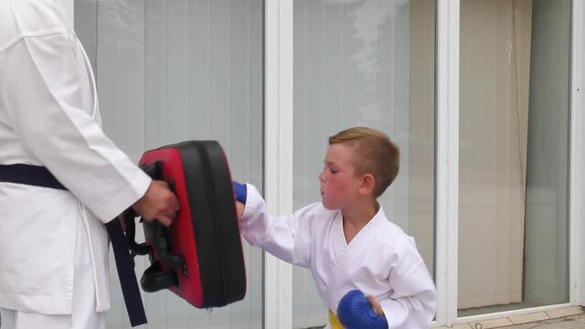 Boy makes a punch on the simulator in motion