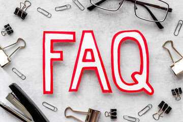 Word faq frequently asked questions with stationery on working place