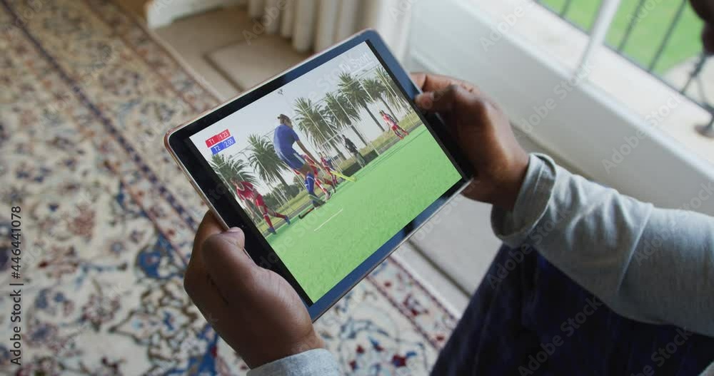 Sticker Composite of man sitting at home, watching hockey match on tablet