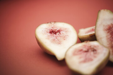 Figs on peach color background. Simple food photography.