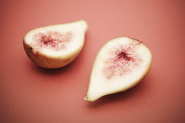 Figs on peach color background. Simple food photography.