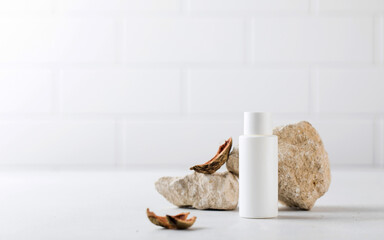 A white tube with an organic cosmetic care product surrounded by natural materials. The concept of eco cosmetics. 