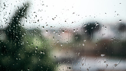 Close up macro shot falling rain water drops bubbles on wet window glass flat house appartment...