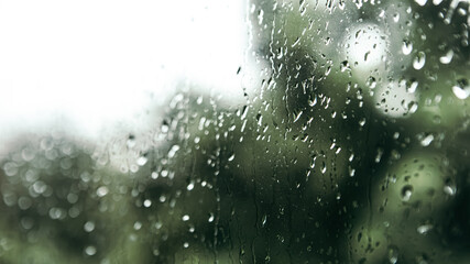 Close up macro shot falling rain water drops bubbles on wet window glass flat house appartment...