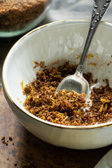 Bowl with mixed lemon zest and brown sugar for filling yeast knot buns.