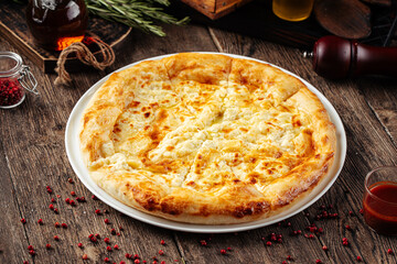 Megrelian khachapuri flat bread with cheese on wooden background