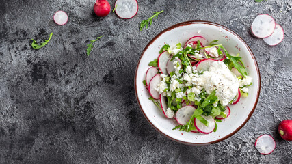 Vegetarian salad of radish, cottage cheese and arugula with sour cream. Healthy vegan food. banner, menu recipe place for text, top view