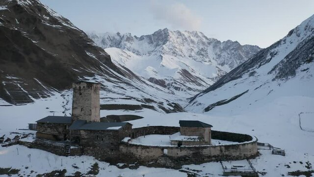 In this aerial drone camera shot you can see LaMaria monastery standing in Ushguli village in Svaneti region, Georgia next to highest Georgian mountain &ndash; Shkhara. UNESCO heritage