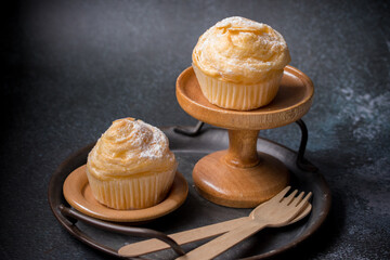 Vanilla cupcakes on a black background