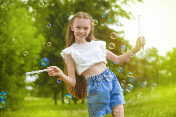 girl blows up soap bubbles