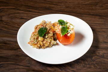 Stuffed tomato with Tabbouleh Salad, vegetarian food. Traditional middle eastern or arab dish.