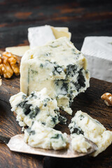 Fototapeta na wymiar Piece of gorgonzola cheese, on dark wooden background