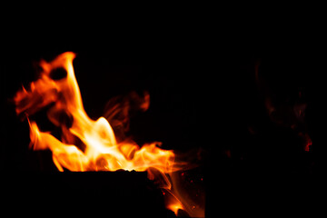Fototapeta na wymiar Natural flames on a radical black background. Ready for use with Adobe Photoshop in screen mode.