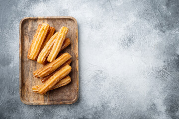 Churros with caramel Traditional Spanish cusine, on gray background, top view flat lay with space for text, copyspace