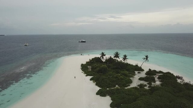 Aerial  Drone Tropical Island on the Maldives with white beaches and azure blue water