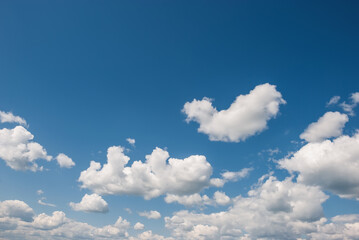 Naklejka na ściany i meble Heap, white clouds in the blue sky. Sky landscape