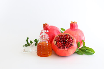 honey and pomegranate isolated on a white. Rosh hashanah (jewish New Year holiday) concept. Traditional symbol