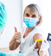 woman wearing mask getting vaccinated concept of coronavirus vaccination mask grown woman approved...