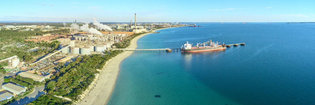 Panoramic shot of Kwinana alumina refinery on a sunny day with industrial plant and docked ship