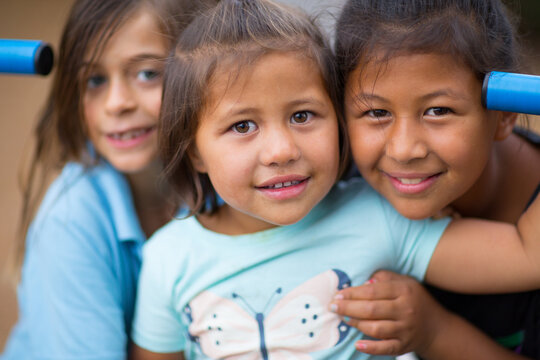 Three little kids close together head and shoulders