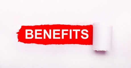 On a bright red background, white paper with a torn stripe and the inscription BENEFITS.