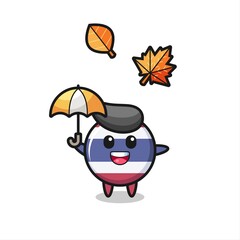 cartoon of the cute thailand flag badge holding an umbrella in autumn