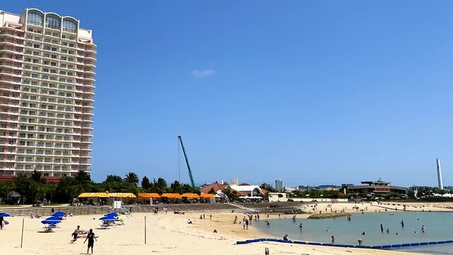CHATAN-CHO, OKINAWA, JAPAN - JUNE 2021 : View of Chatan sunset beach (Ocean or sea). Wide view, time lapse tracking shot in daytime. Holiday, vacation and resort concept shot.