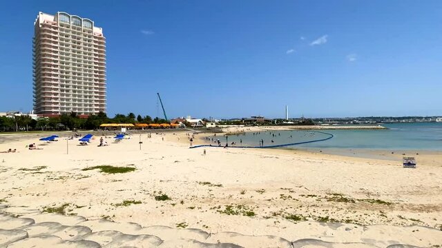CHATAN-CHO, OKINAWA, JAPAN - JUNE 2021 : View of Chatan sunset beach (Ocean or sea). Wide view, time lapse zoom in shot in daytime. Holiday, vacation and resort concept shot.