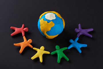 Multicultural people around Earth. Justice and no racism concept. Gender and racial equality. DIY. Children's crafts from colored plasticine. Group of people around the world. - obrazy, fototapety, plakaty