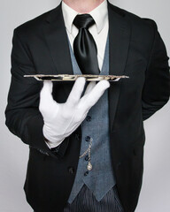 Butler in White Gloves Elegantly Holding Silver Serving Tray. Concept of Service Industry and Professional Hospitality.