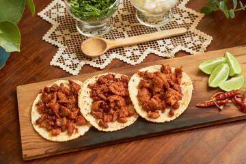 Fototapeta na wymiar Authentic Mexican tacos on wooden table. Mexican gastronomy concept.