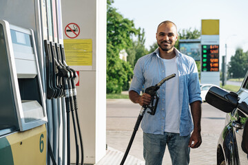 Man filling gasoline fuel in car at gas station