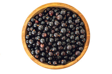 Fresh black currant in wooden bowl on dark table