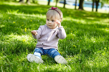 Little girl play in the park and have a good time. The concept of a happy childhood, spring outdoor recreation