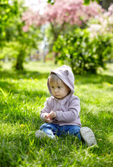 Little girl play in the park and have a good time. The concept of a happy childhood, spring outdoor recreation