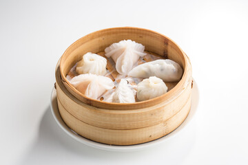 Fototapeta na wymiar Chinese dim sum dumplings in bamboo basket isolated on white background