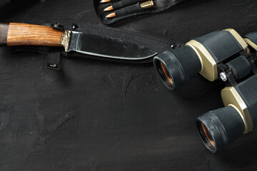 Hunting equipment on old dark wooden background