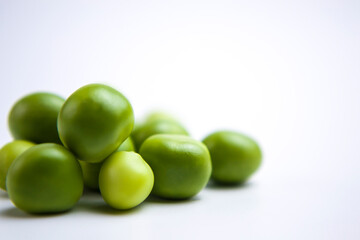 Falling green peas isolated on white background with clipping path