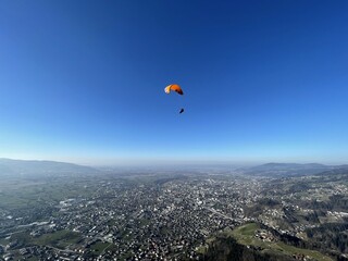 Paraglider in front of blue sky in Dornbirn, Vorarlberg.