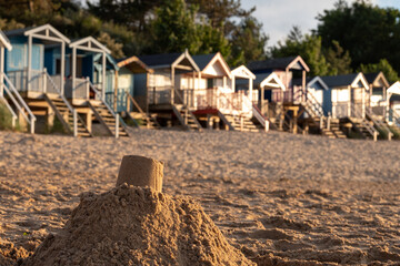 Row of characterful, colourful beach huts on the sea front at Wells-next-the-Sea, North Norfolk UK....