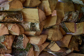 Natural rustic wooden background, dry chopped wood for a winter stove