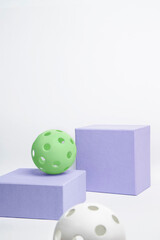 Picball balls, on purple cubes, side view.