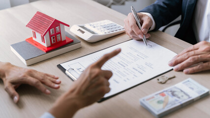 Real estate broker and client  sign contract insurance agreement document. Business meeting concept.